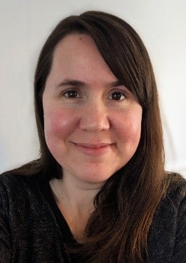 female with dark hair smiling in black shirt 
